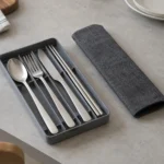 Partitioned cutlery kit with slide tray and removable sleeve