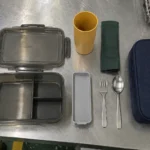 Factory worker meal kit components arranged on a stainless quality inspection table