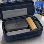 Open navy carry case showing the lunch box tumbler sleeve and removable insert