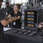 Event staff distributing meal boxes from an insulated shelf carrier
