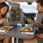 Two travelers using the coordinated campervan dining kit inside a rental vehicle