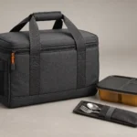 Closed graphite insulated carrier beside one meal box and cutlery sleeve
