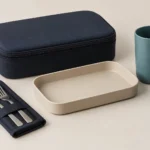 Closed navy carry case beside compact rail meal service components