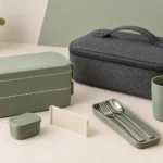 Closed charcoal carry case beside the modular sage office lunch set