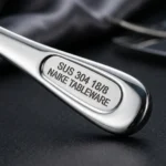 Macro detail of SUS 304 18/8 NAIKE TABLEWARE stamped handle with mirror reflection